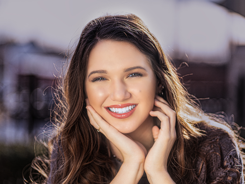 woman putting in clear aligners