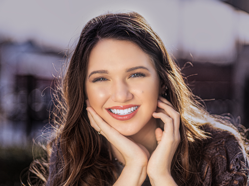 woman putting in invisalign clear aligners